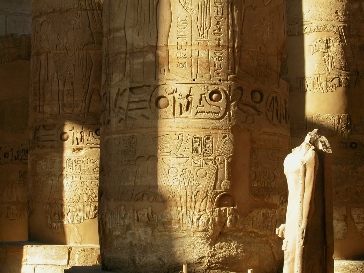 Ancient carved temple columns lit by warm sunlight