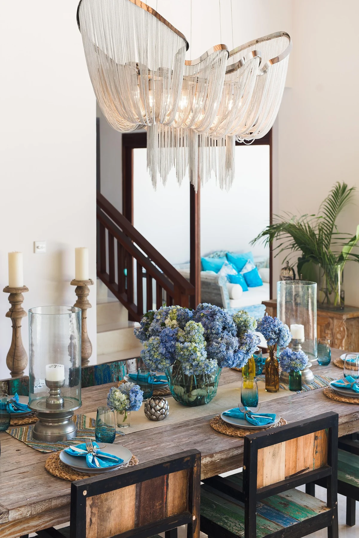 Elegant dining room with blue floral table setting and chandelier
